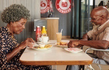 Old couple enjoying a Wimpy meal