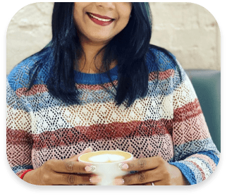 Lady holding a cup of coffeee