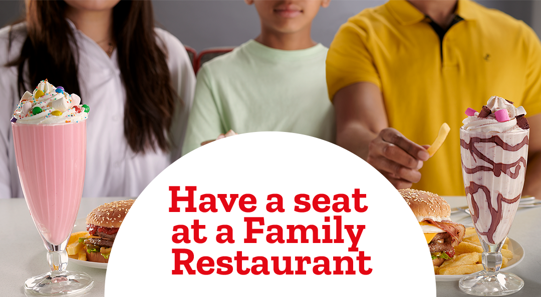 Family sitting at restaurant table