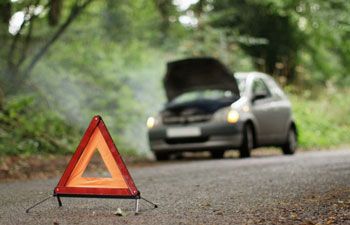 Car on side of the road with warning triangle