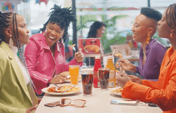 Four women sharing Wimpy’s 1/4 Chicken Meal with a free Coke.