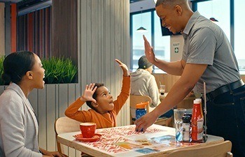 Little kid giving a waitron a high five