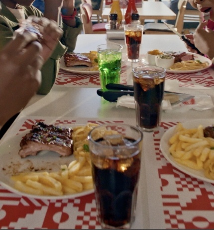 Group of people eating Wimpy at a table