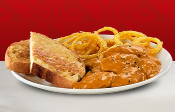 Creamy peri-peri chicken livers with crispy onion rings and toast